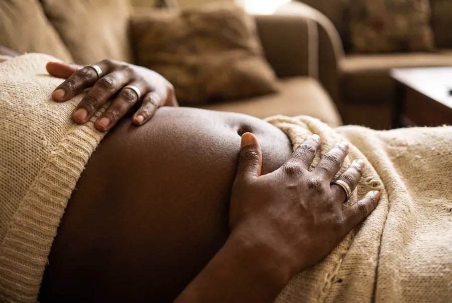 Hands resting on the abdomen, gut health testing