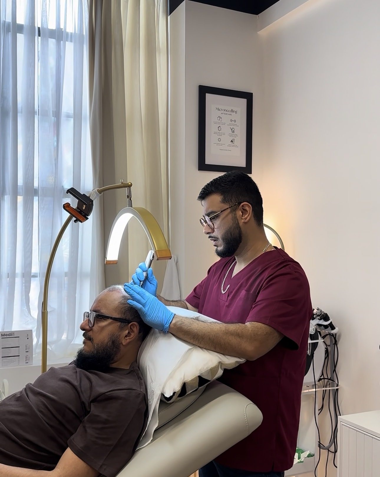 Arman Zaki, GMC-registered Physician Associate, performing EXO-GROW scalp microneedling with the Dermapen 4 on a client in the treatment room at Melatone Skin Clinic, Battersea